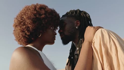 Romantic Couple Touching Foreheads Outside on Sunny Day