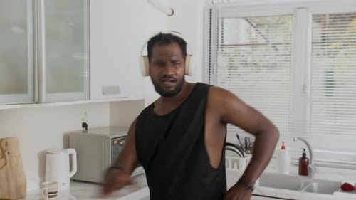 Man Dancing and Singing in Kitchen with Headphones