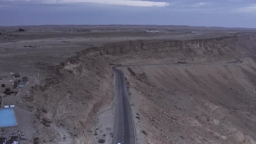 Road with cars in the desert at Sunrise, Aerial view