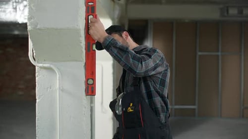 Builder Engineer Caucasian Man Measuring Wall with Ruler on Construction Site Think Doubt Problem