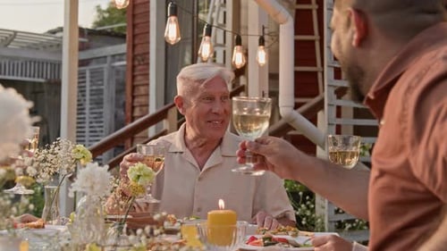 Senior Man Hosting Family Dinner