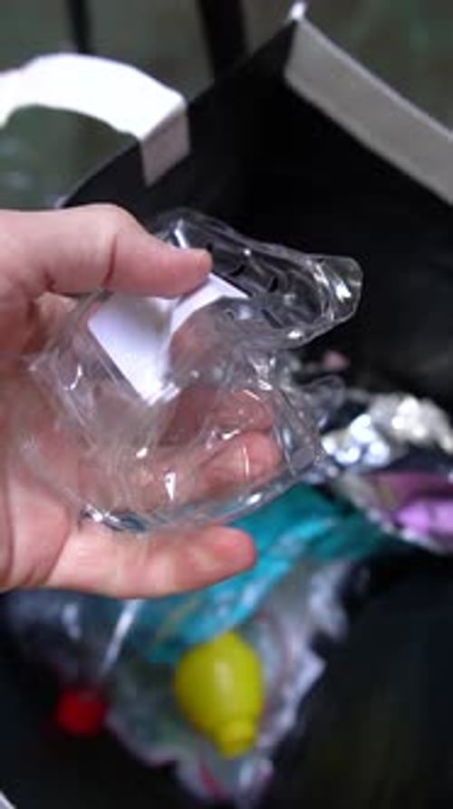 Close-up of Hand Squeezing plastic Stuff for Green Initiative