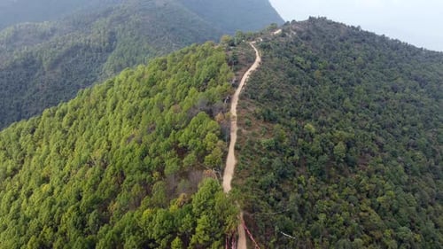 An aerial flight over the forested foothills of the Himalaya Mountains in Nepal.