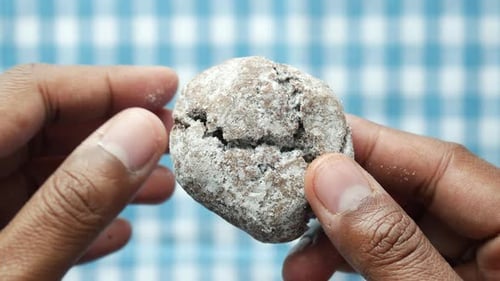 Chocolate Cookie Being Broken in Half