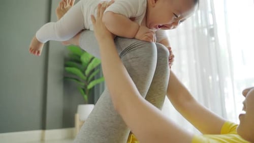 Happy Infant Plays with Loving Parent at Home