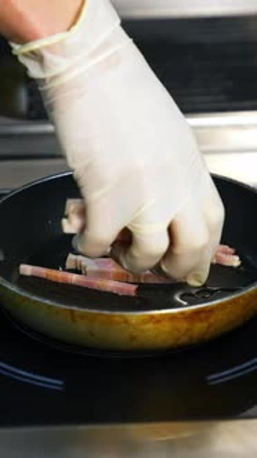 Chef Adding Bacon to Frying Pan