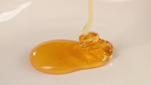 Honey Poured On A White Plain Background. Organic Thick Honey, Sweet Dessert