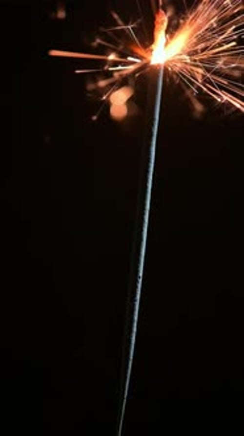Burning Sparkler Against a Black Background at Night