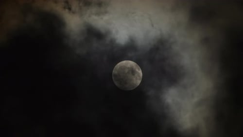 Full moon with clouds moving in the foreground