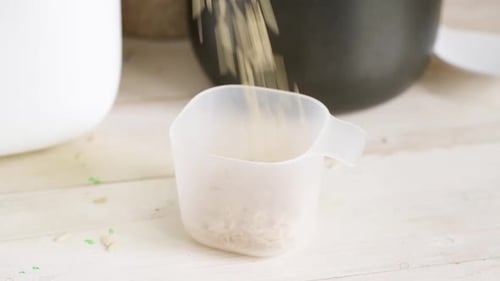 Rice Fills Measuring Cup in Close Up Shot