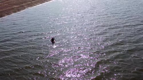 Aerial view of a single Kayak in reflected light on the sea at Hunstanton, UK.