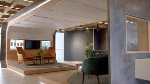 Modern office lounge area with stylish furniture and plants, creating inviting space, copy space