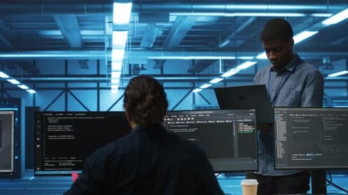 Team Leader at Work in Data Center Supervising Workers Mending Rigs