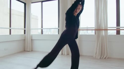 Stylish Woman Dances in Urban Studio