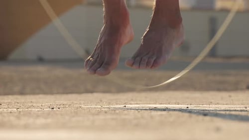 Outdoor Sport Training Man Jumping with Rope Joyful Athlete is Energetically Jumping and Skillfully