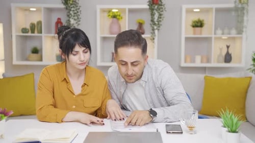 Couple Reviewing Documents Together at Home