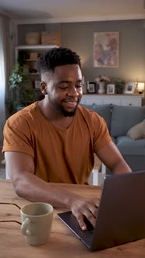 Man Working on Laptop at Home