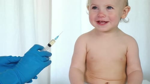 Doctor Vaccinating Baby in Clinic