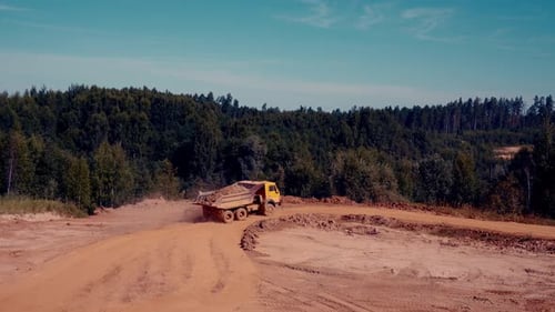 Dump Truck Hauling Dirt on a Dirt Road