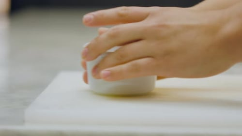 Placing Ramekin on Cutting Board Close Up