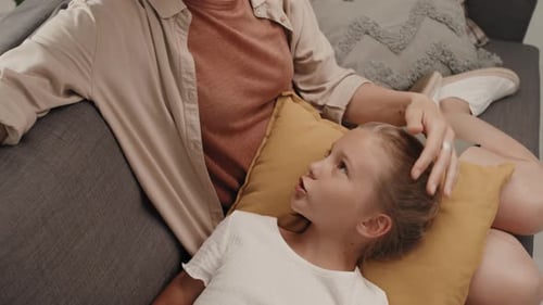 Woman and Child Relaxing Together on Couch