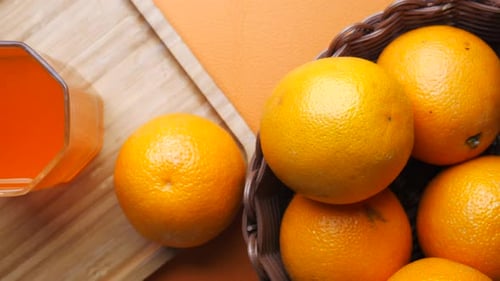 Fresh Orange Juice and Oranges in a Basket