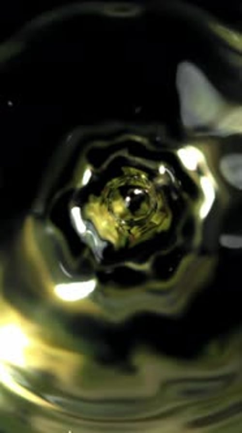 A Drop Falls Into a Glass of White Wine Filmed on a Highspeed Camera at 1000 Fps