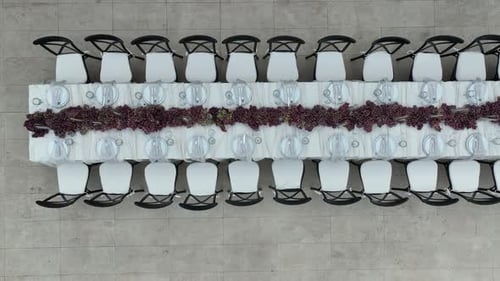 Elegant Outdoor Event Setup with Long Table by a Pool and Greenery