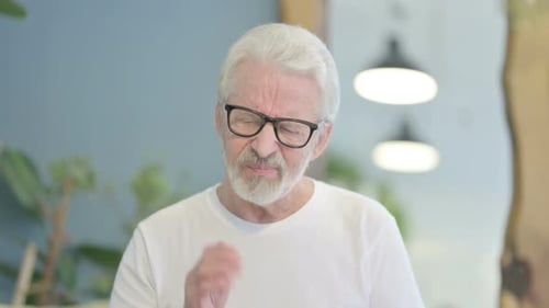 Senior Man Suffering from Toothache Indoors