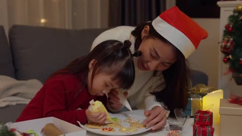 Festive Mother and Child Decorating Christmas Cookies