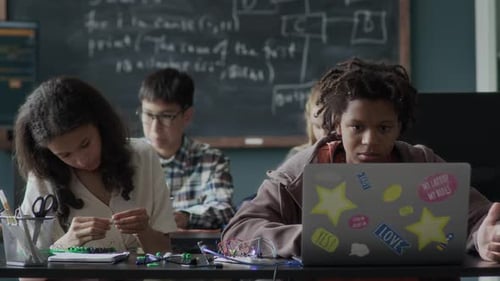 Multiethnic Gen Z Students Studying Programming in Class