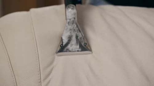 Close Up Professional Cleaning of an Apartment Cleaner Vacuuming with Detergent Textile Sofa