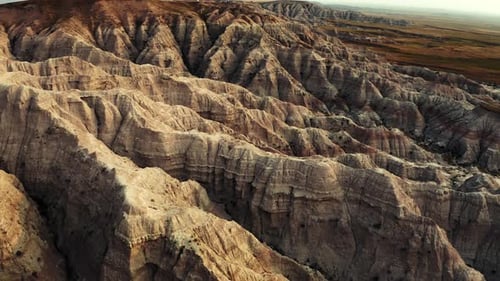 Beautiful panning aerial drone shot of a desert canyon terrain landscape. It almost looks as if it w