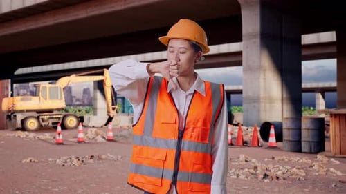 Asian Female Engineer Showing Thumbs Down Gesture And Shaking Her Head At Building Site