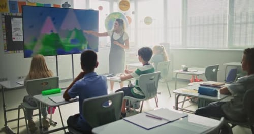 Geography Class Female Teacher Teaching Primary School Children Using Digital Screen