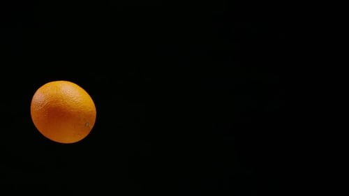 Fresh Orange Rotating on Black Background