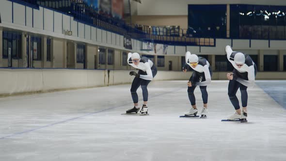 Three Speed Skaters Training on Racetrack in Rink, Sports Stock Footage ...