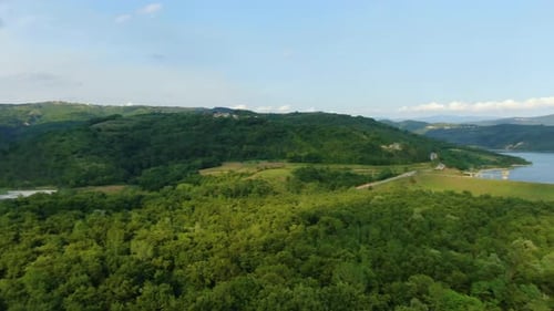 Lake Butoniga water reservoir in Croatia high altitude panorama with wide angle aerial drone reveal