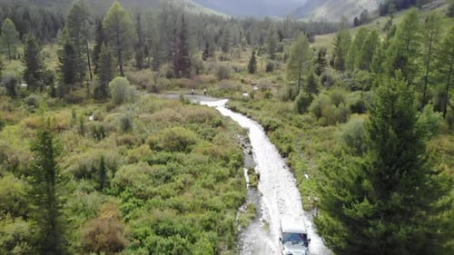 Off Road Vehicle Driving on Muddy Road in Mountain Valley Media