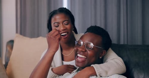 Affectionate Couple Laughing Together on Couch