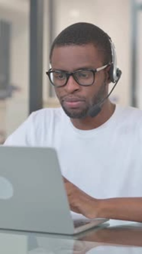 Serious African American Man with Headset in Call Center, vertical video