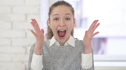 Woman Reacts with Joy and Celebration Indoors