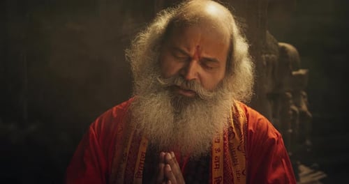 Slow-Motion Close-Up of Old Indian Monk Chanting in an Ancient Temple. The Senior Guru Sings Reli