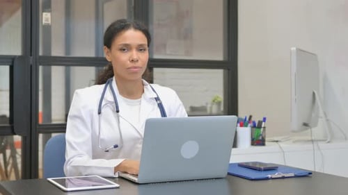 African Female Doctor Smiling at Camera in Hospital