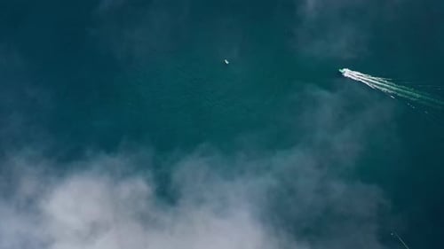 Aerial Top view of a transparent blue sea with beautiful waves at sunny day in summer. air of ocean