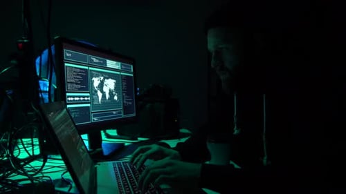 Man Coding on Computer in Dark Room