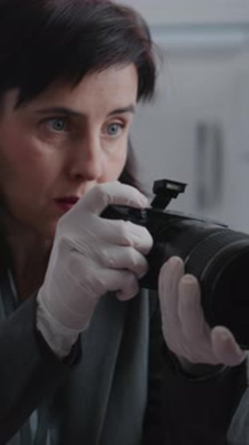 Close Up of Female Criminalist Taking Photos of Evidence at Crime Scene with Camera