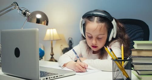 Girl Studying Online at Desk with Laptop