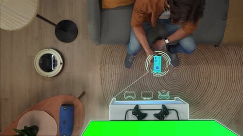 Top View of Man Sitting on the Sofa Switching on Tv Chroma Key Green Screen and Gadgets Using App on