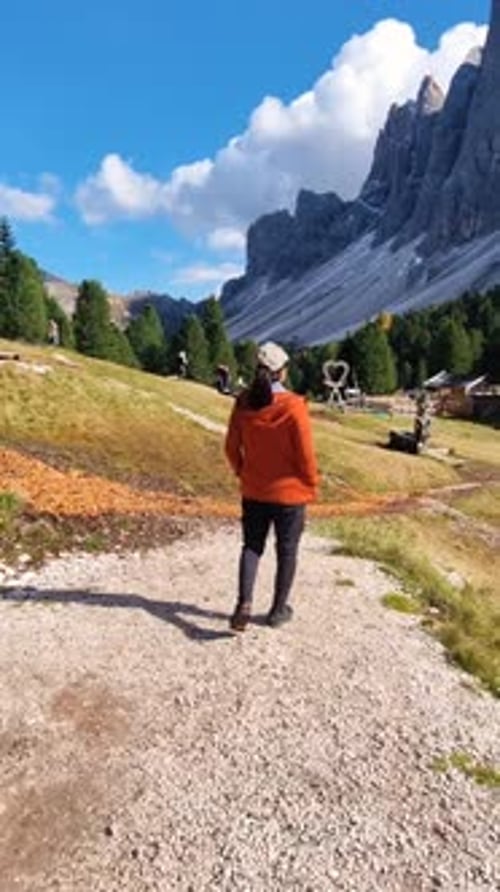 Enjoying a Peaceful Walk Along a Scenic Path in the Dolomites Mountains on a Sunny Day